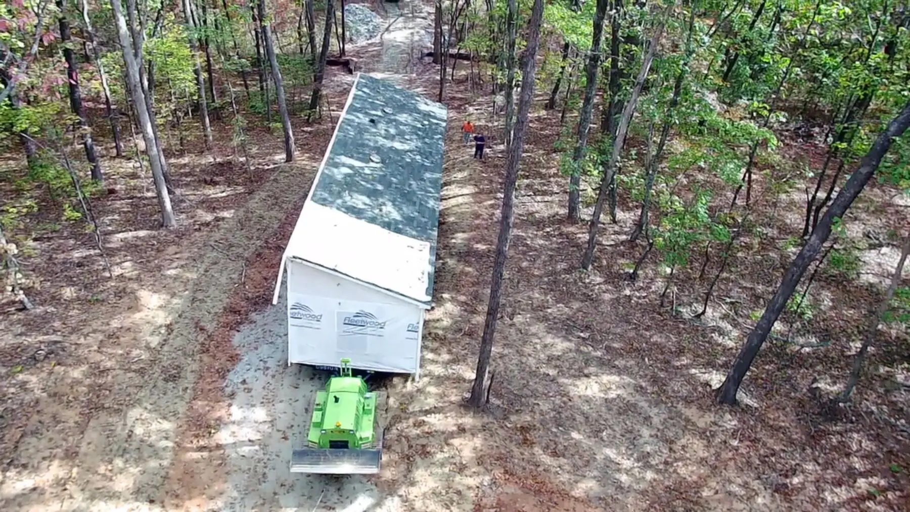 Aerial view home placement in forest.