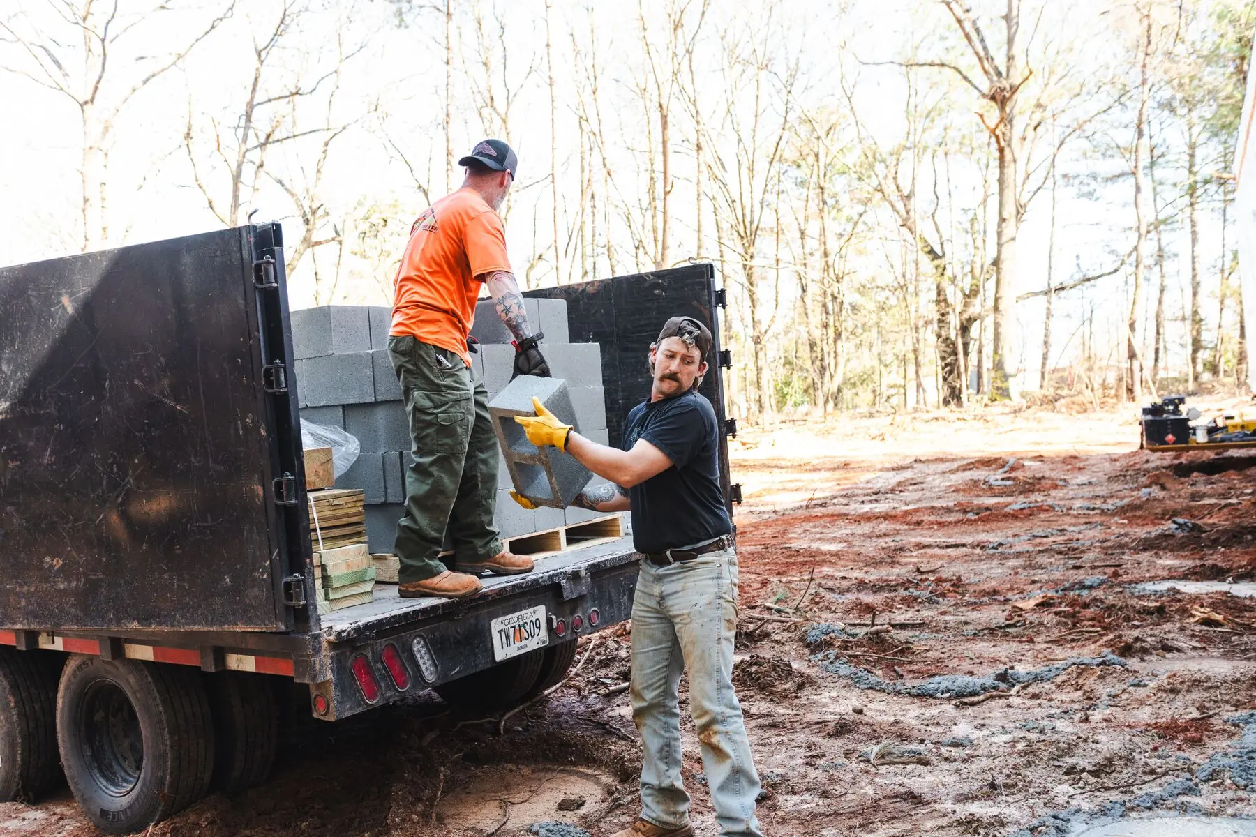 Crew unloading foundation blocks.