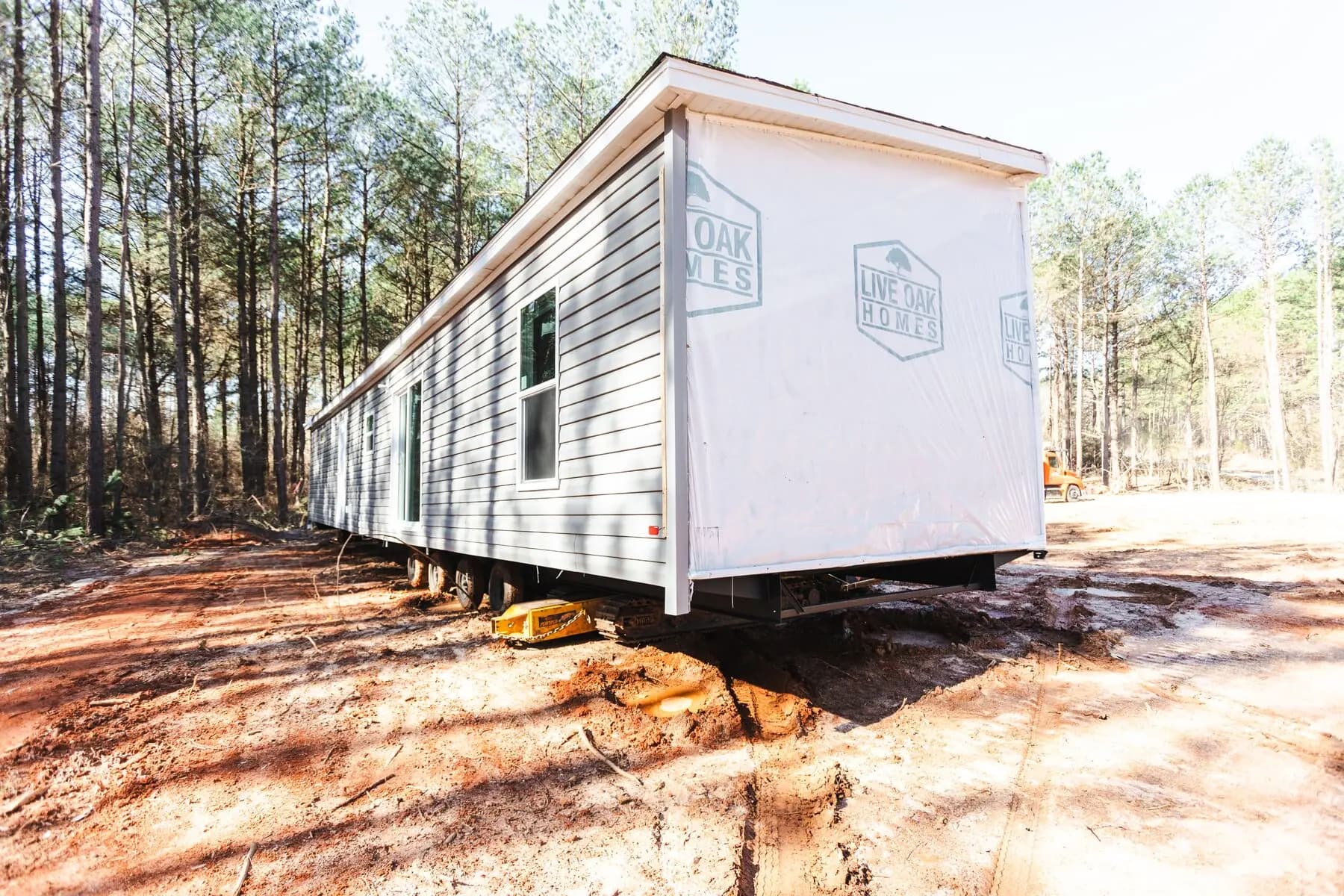Home section set in wooded clearing.