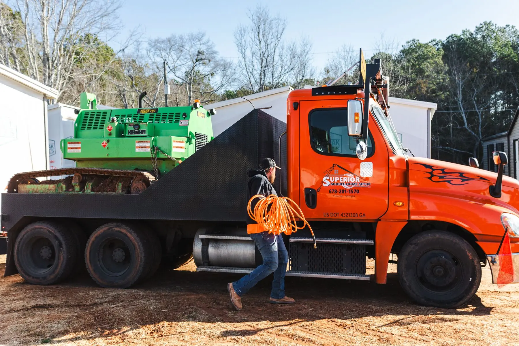 Orange truck and house tug at yard.