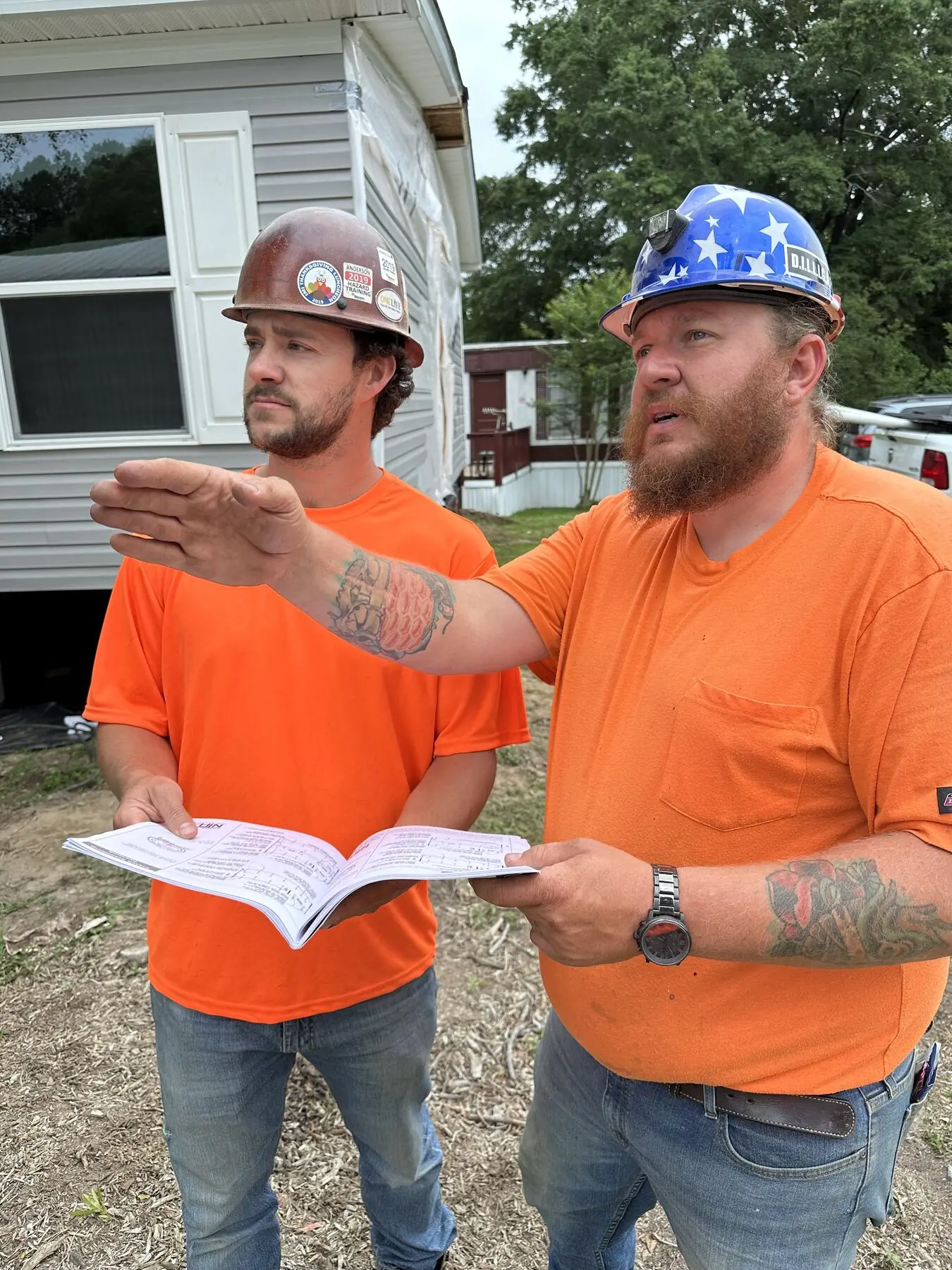 Superior field team reviewing blueprints.