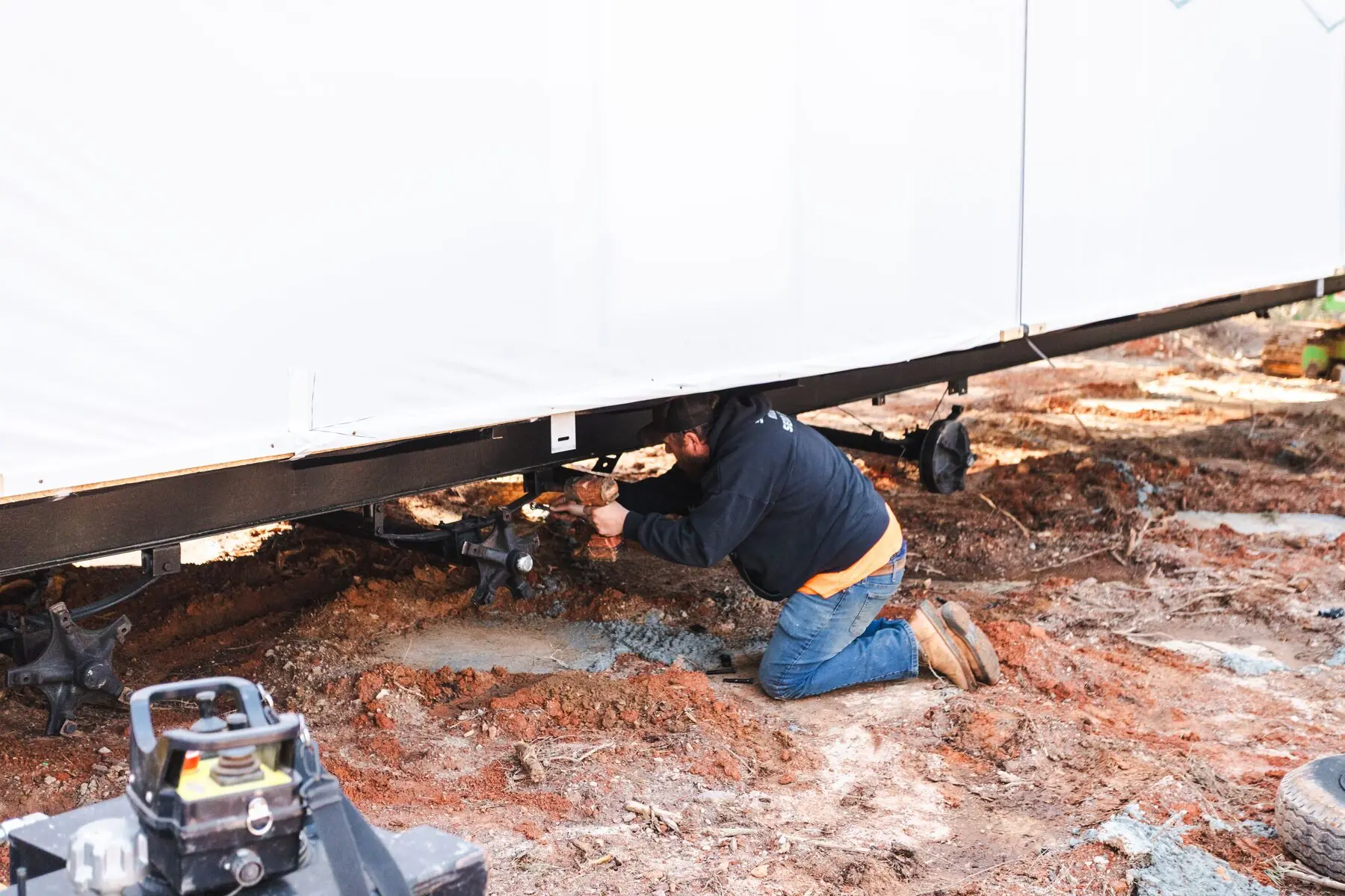 Technician working under home frame.