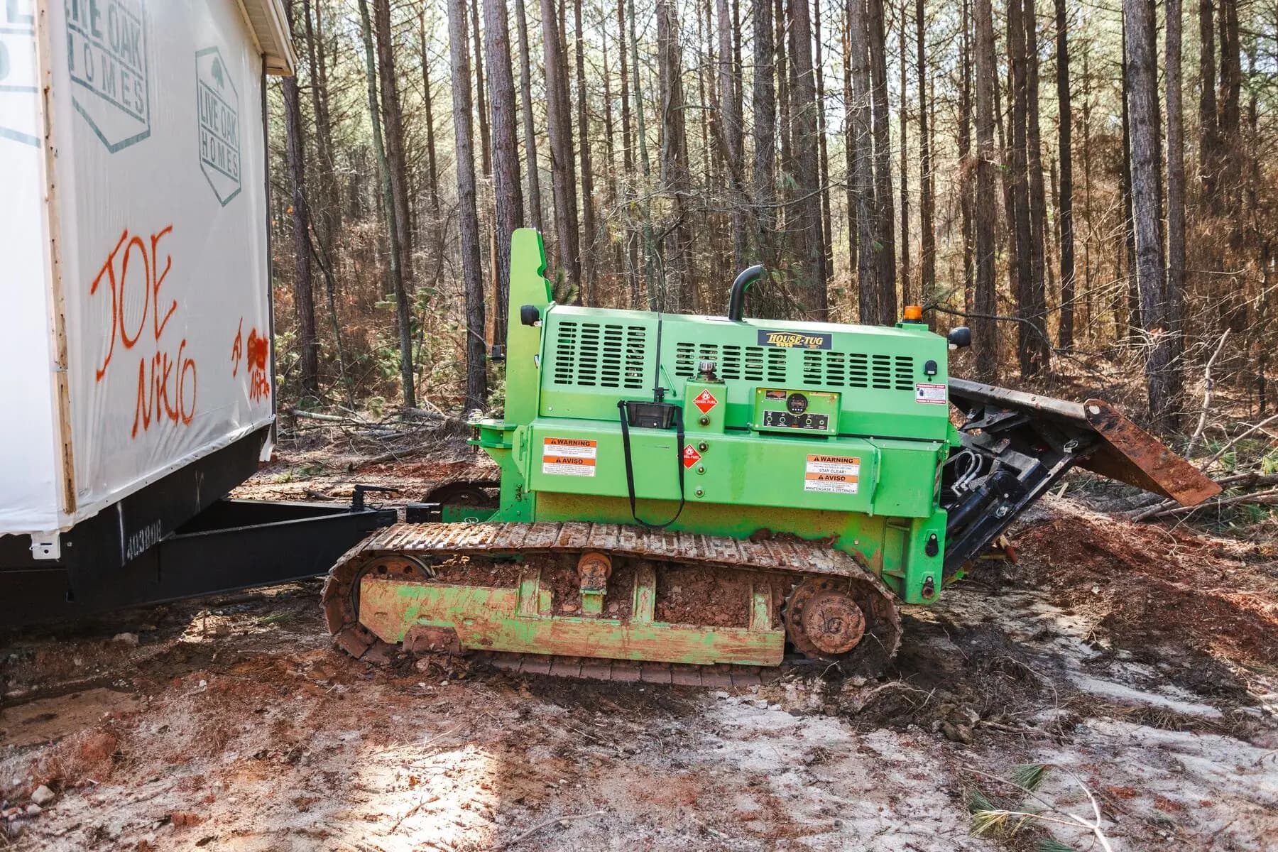 Tracked house tug positioning home.