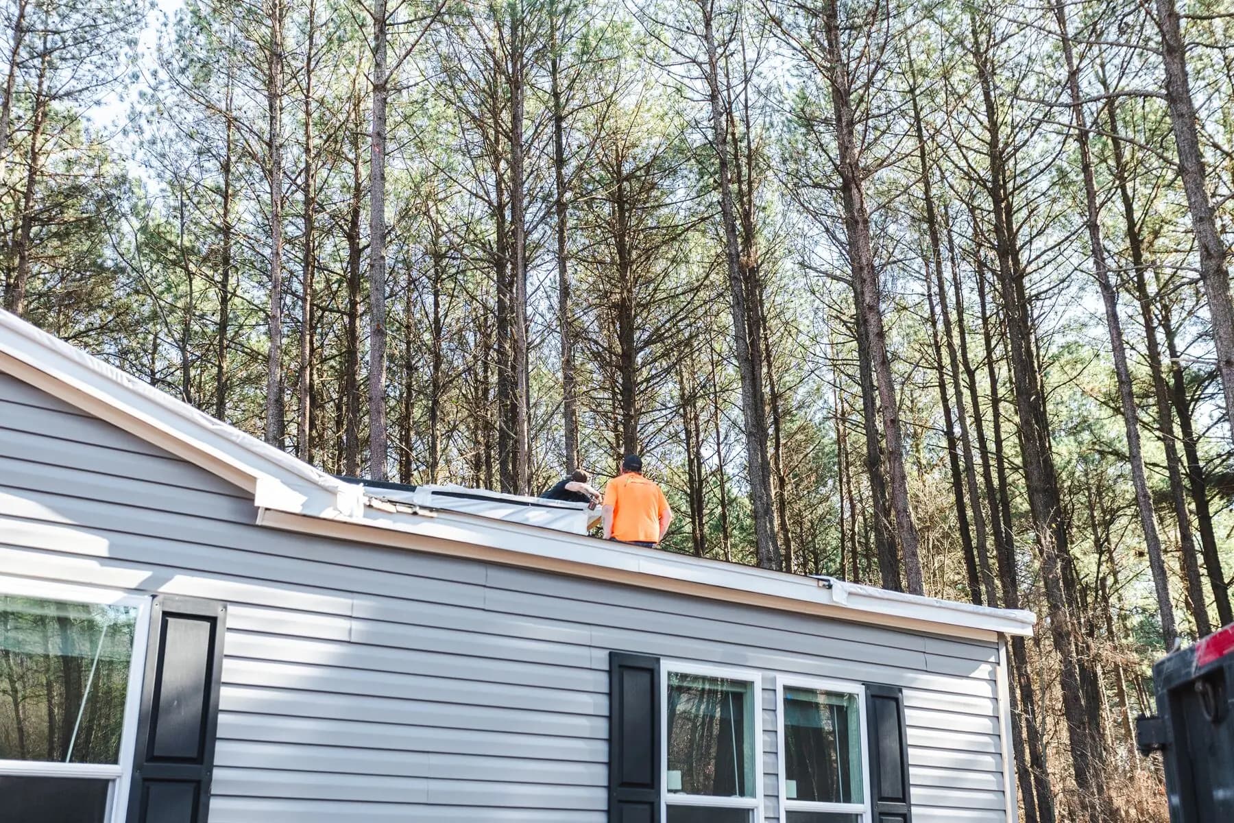 Worker finishing manufactured home roof.
