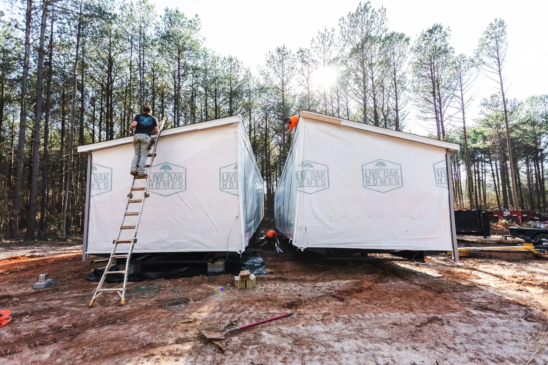Workers joining double wide roof.
