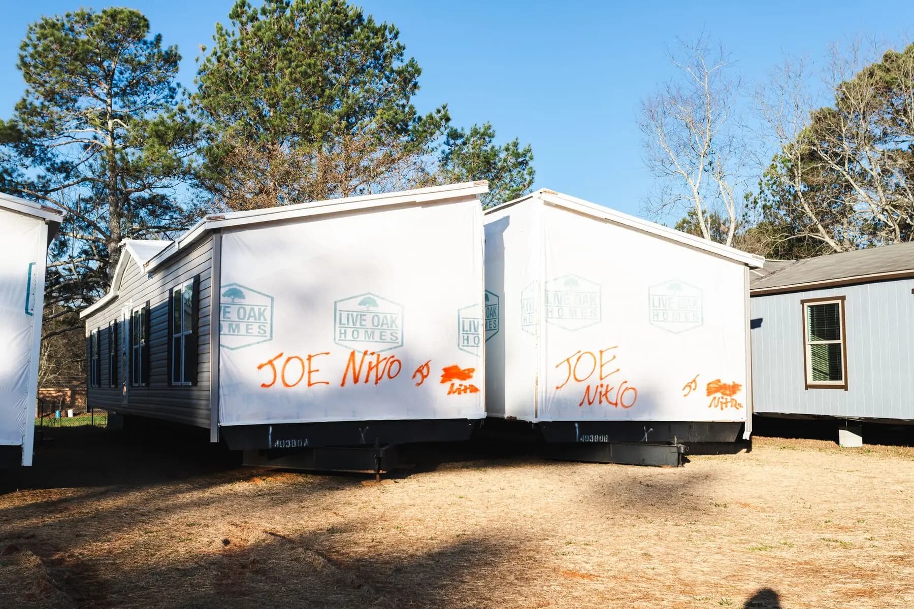 Wrapped double wide sections dealer yard.